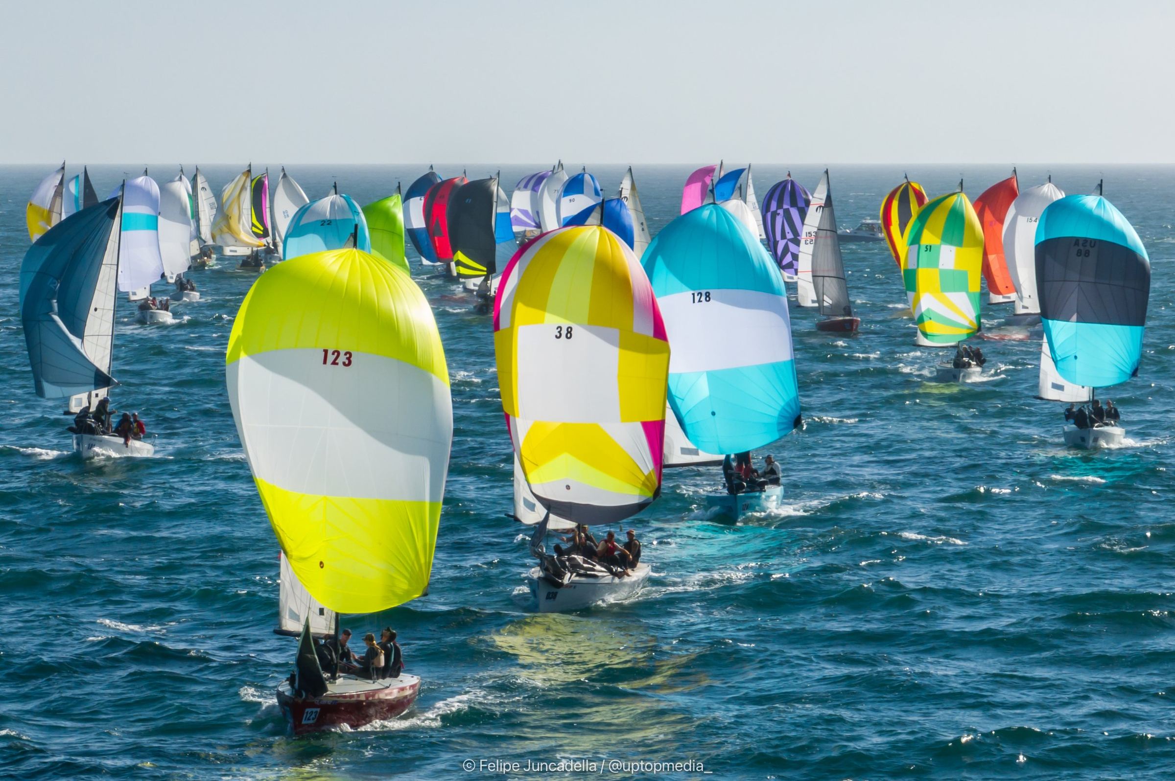 Dozens of Moore 24s racing downwind under brightly colored spinnakers on Monterey Bay