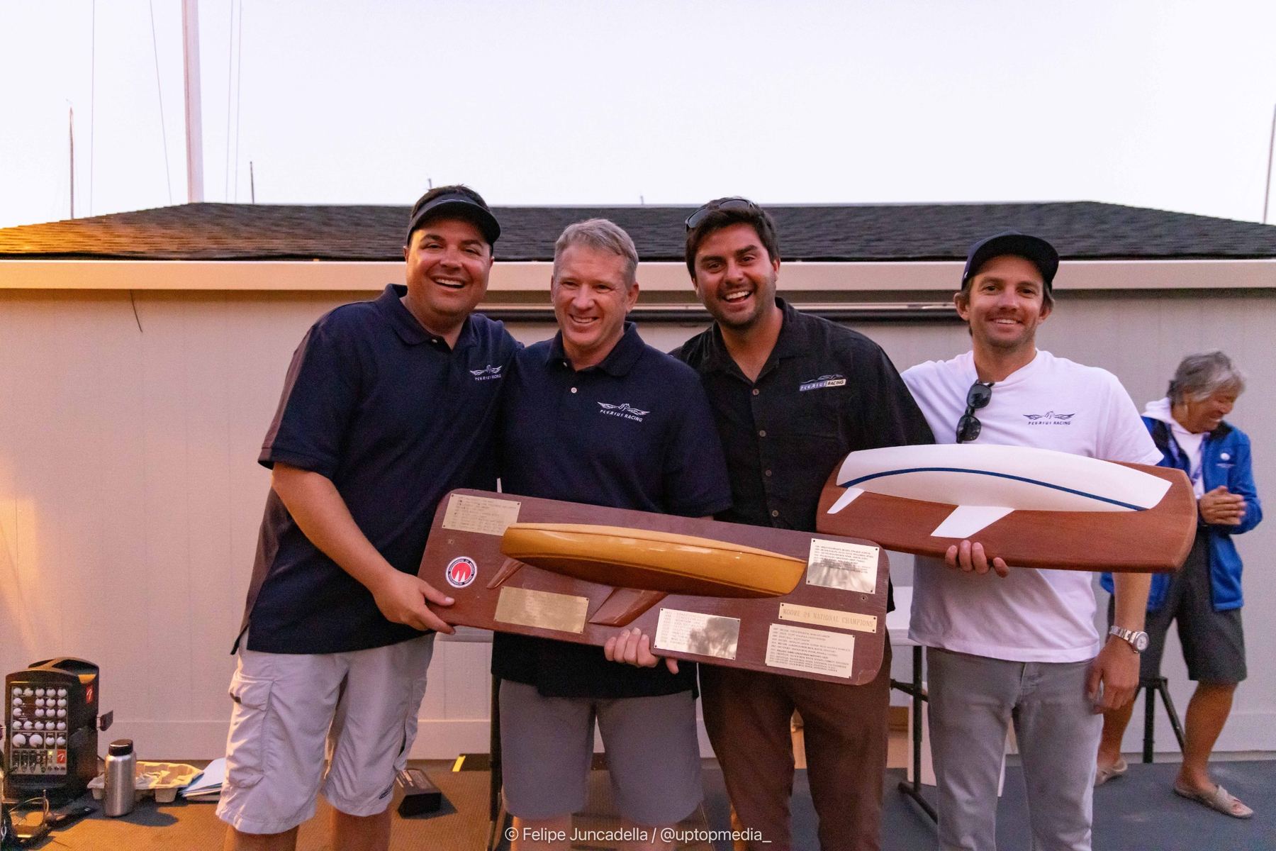 The Pegasus Racing team holding the Moore 24 National Champions trophy and a half-model award at the prize giving